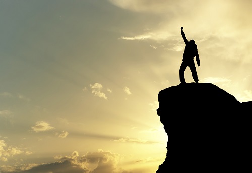 Man on top of mountain